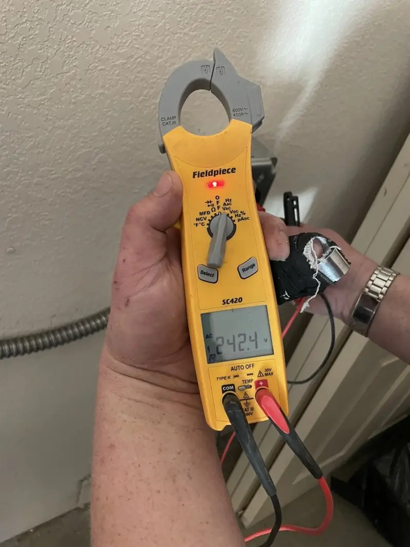 Voltage testing with clamp meter during Recessed Lighting Installation in Albany